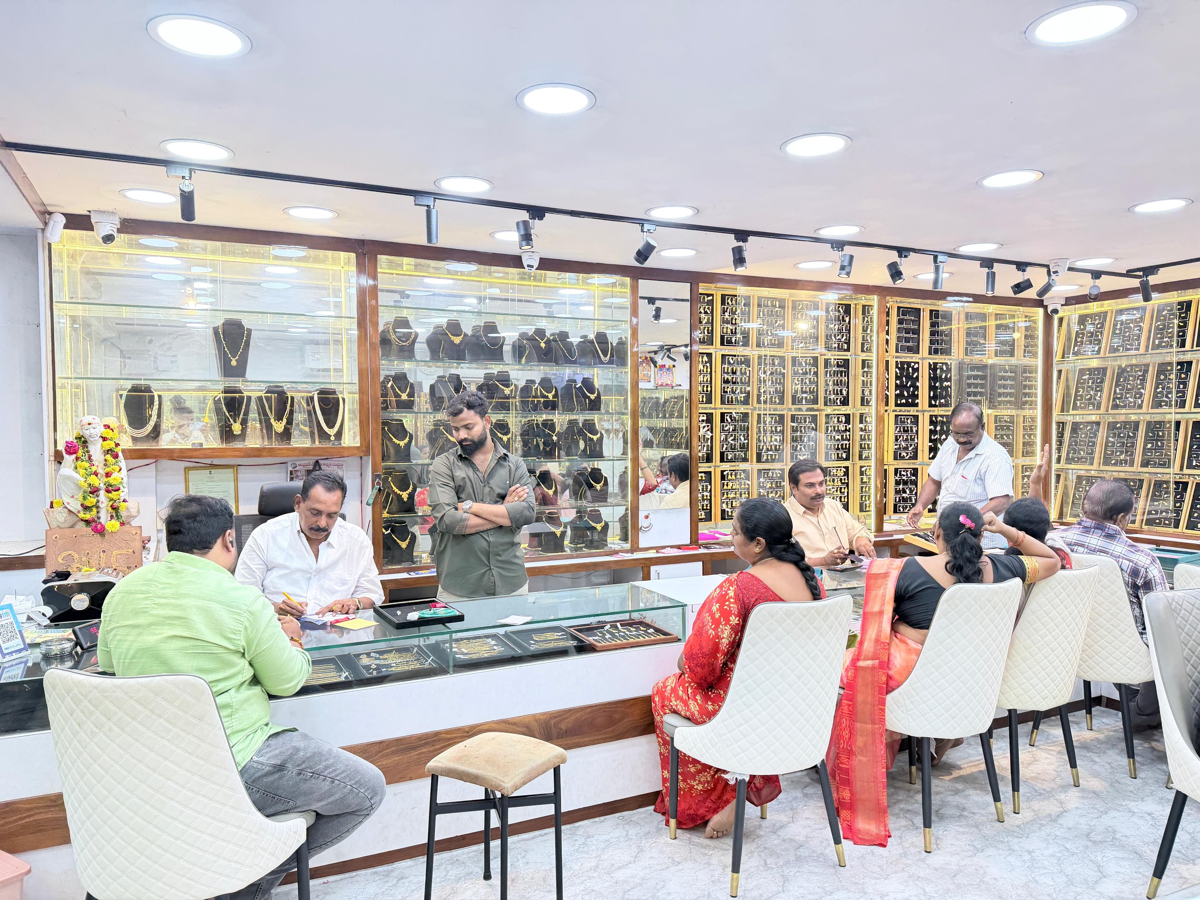 Customers exploring gold jewellery inside Sai Praveen Jewellery showroom